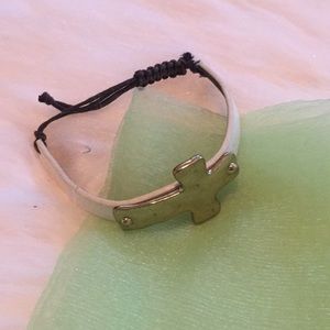 White leather band w/silver cross bracelet.